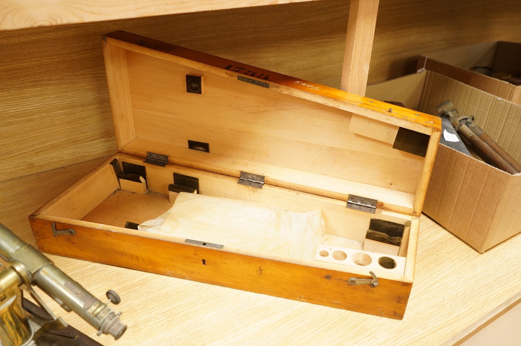 A German brass alidade by F. Sartorius, Göttingen, number 1755, 58.5cm wide, contained within a fitted birch case with applied maker’s label and other reference markings, the case; 63cm wide, 14cm high, 25cm deep at the